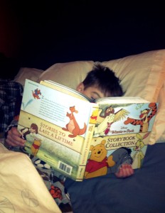Liam reading his favorite Winnie the Pooh stories