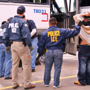 U.S. Immigration and Customs Enforcement Agents transporting suspects after a raid